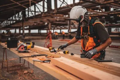 Carpenter measuring and cutting wood